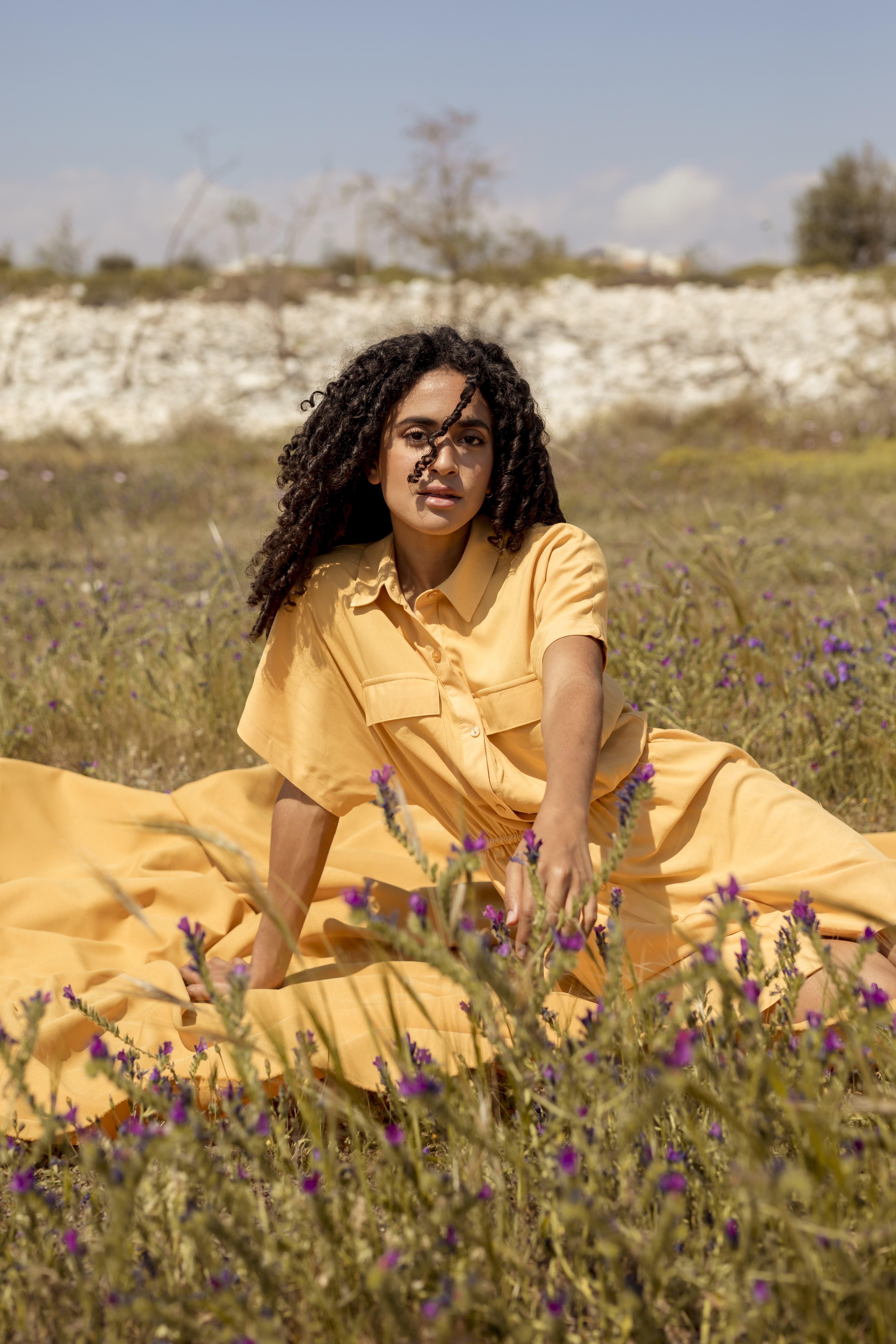 young-woman-lying-yellow-cloth-nature