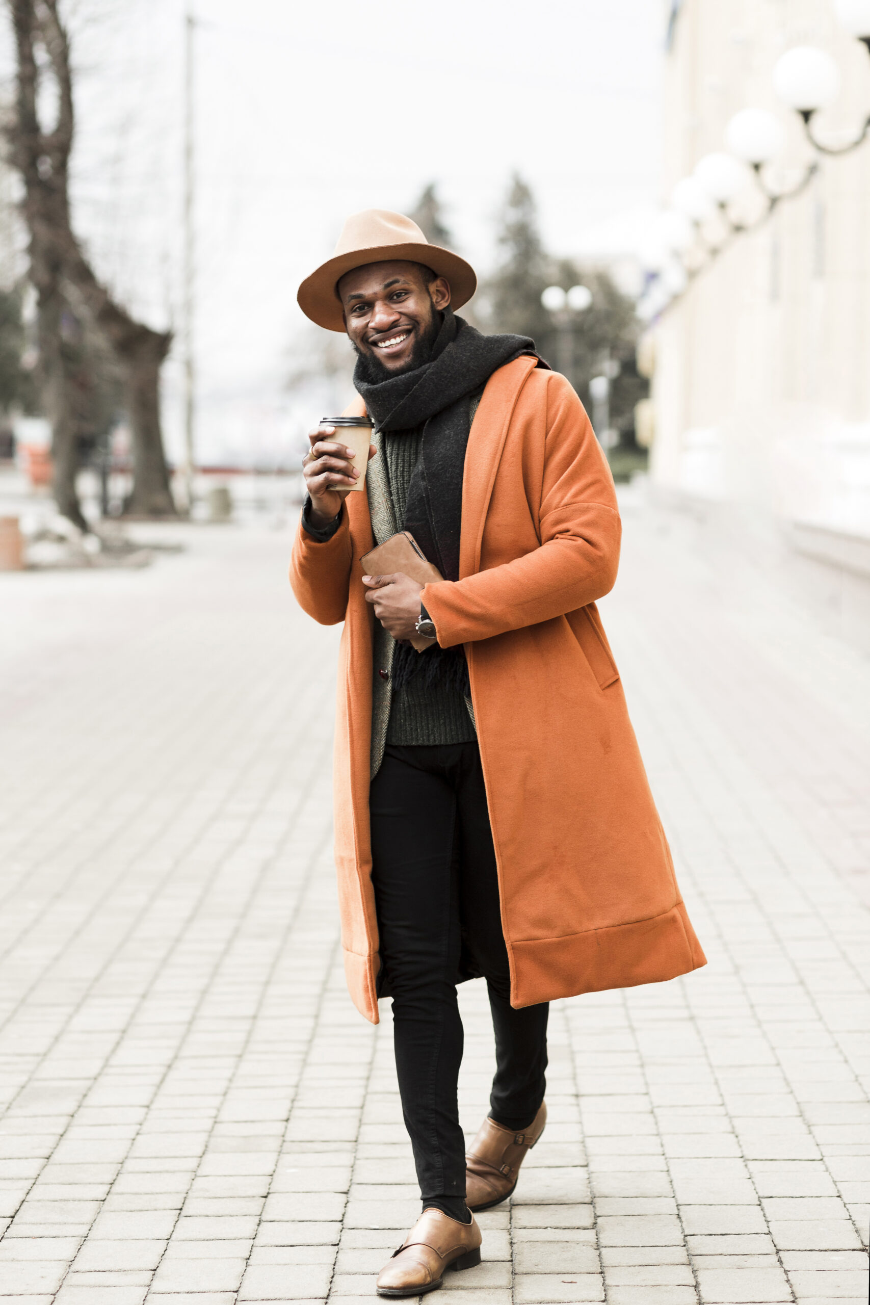 front-view-man-orange-coat-holding-cup-coffee