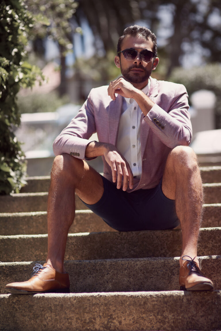 Sunglasses, suit and portrait of man in city on stairs for fashion, style or cool outfit in Italy. Shades, trendy and confident person outdoor on steps in blazer or clothes to relax in urban town.